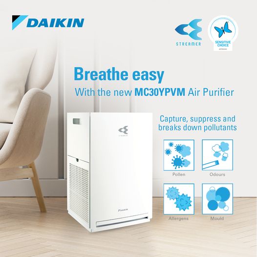Daikin air purifier advertisement with text 'Breathe easy with the new MC30YPVM Air Purifier' in a room setting.