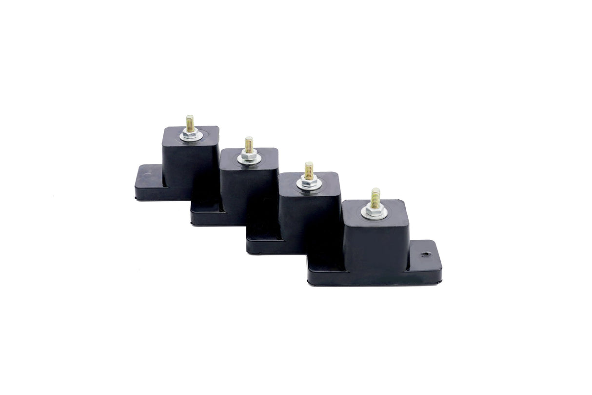 Set of black rubber blocks with metal studs on a white background