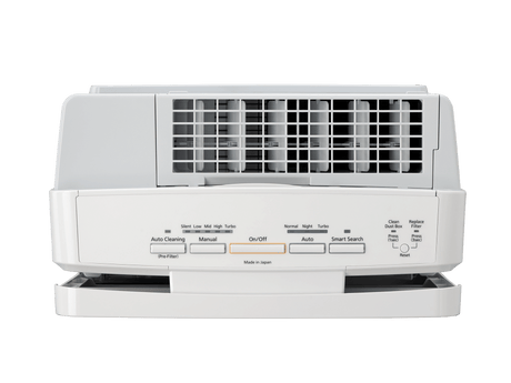 White air conditioner on a green background