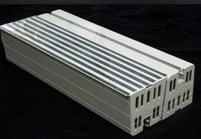 Rectangular plastic component with ribbed surface on a black background