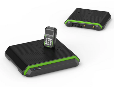 Black and green electronic scale with a remote control on a white background